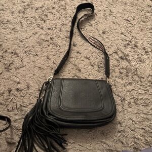 Black leather crossbody bag with tassel detail #crossbodybag